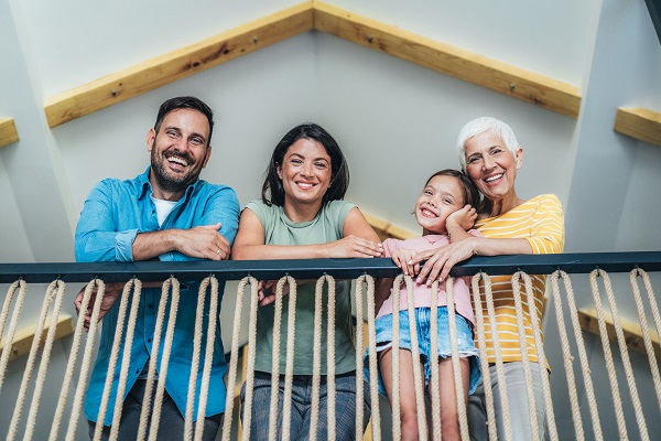 Cheerful, loving multi-generation family in their home posing and smiling